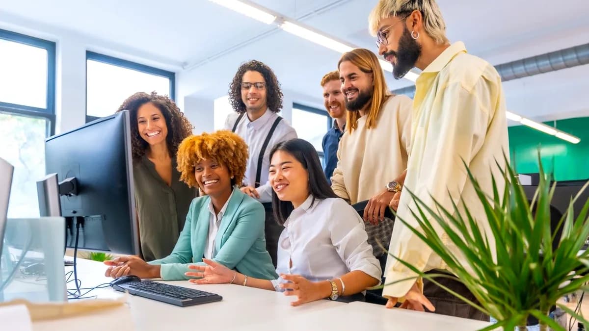 A small business team reviewing workflow information together at a computer